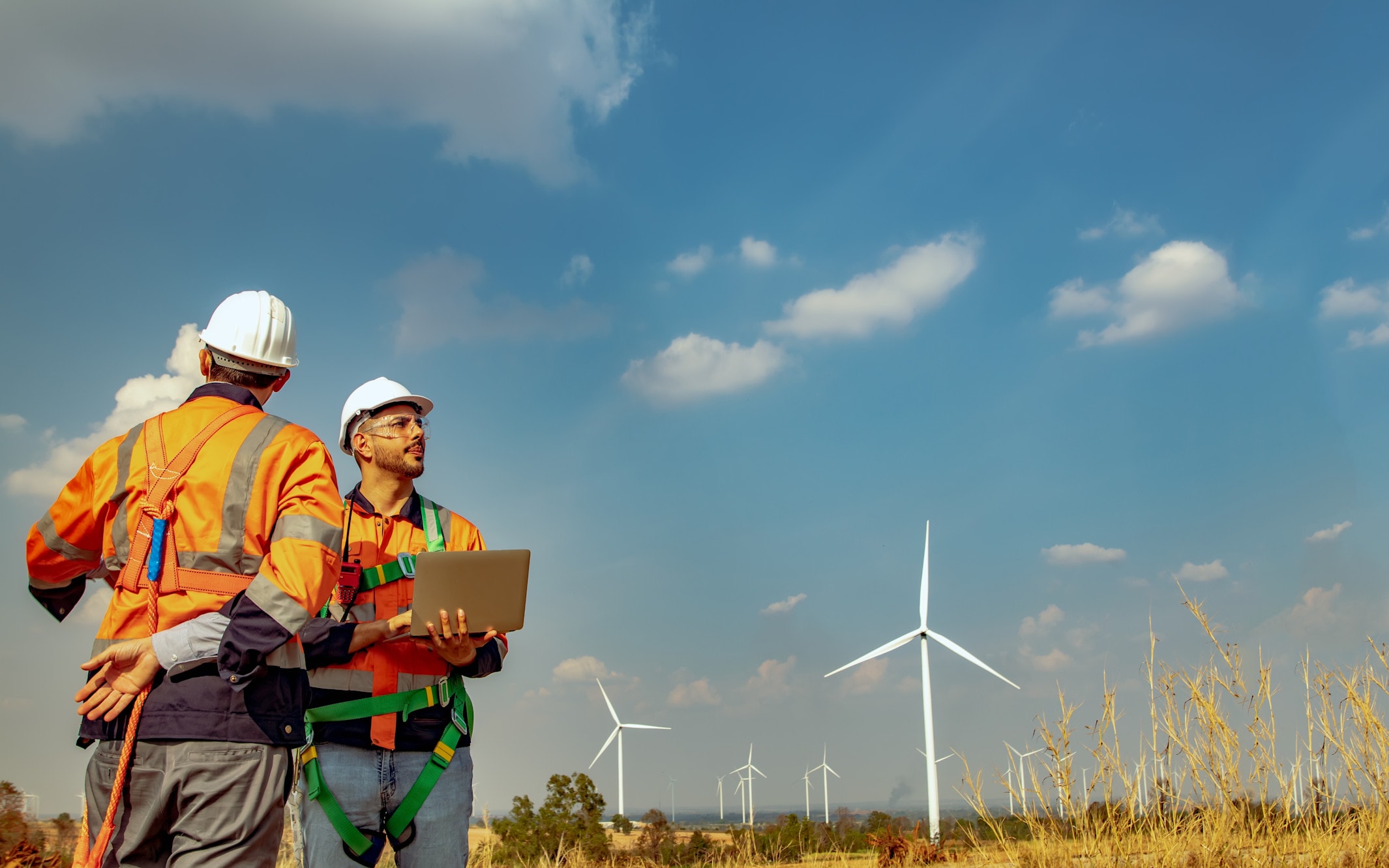 Wind farm with workers in foreground