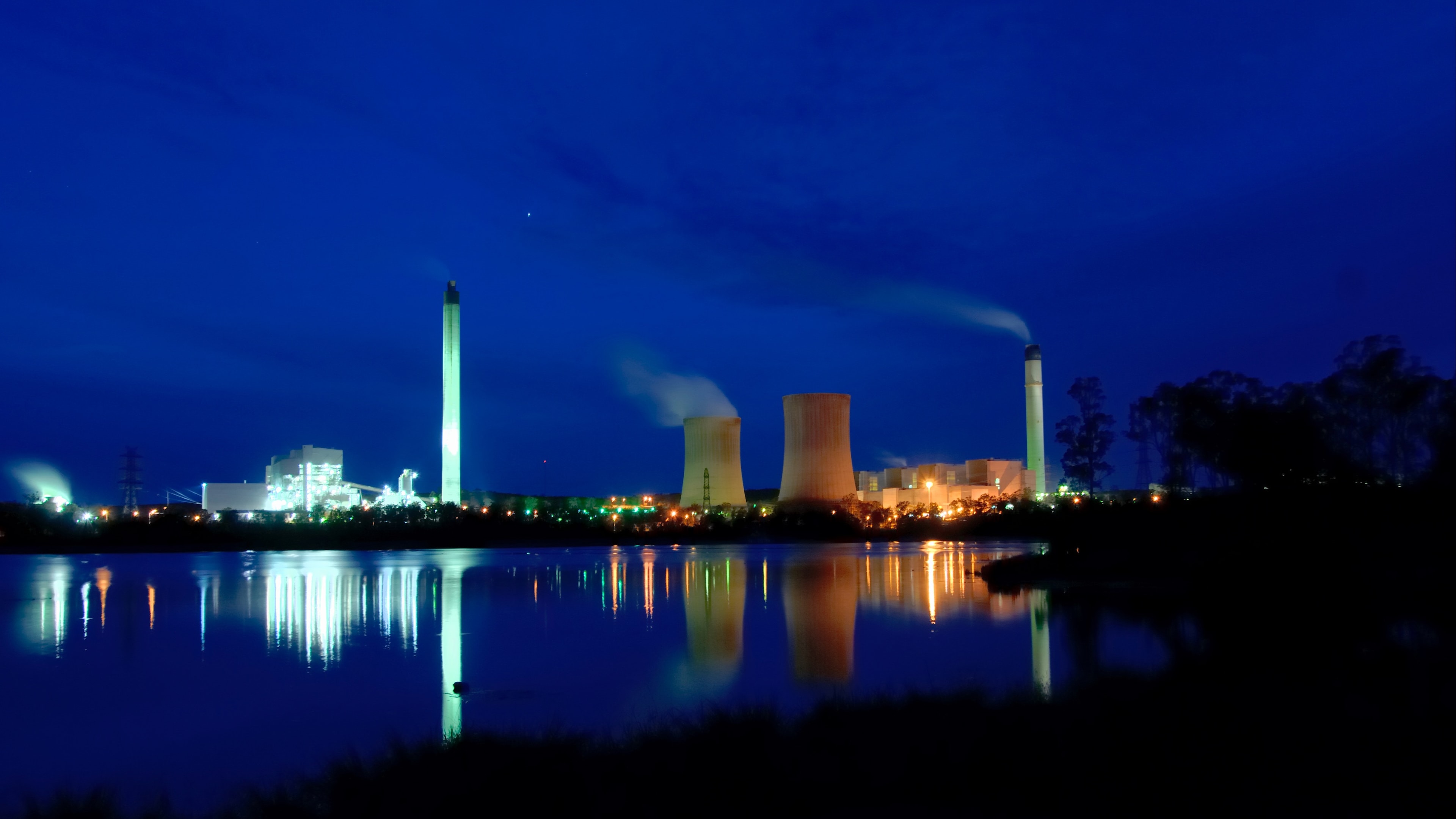 Tarong power station over water at dusk